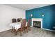 Dining room with blue accent wall, fireplace, and hardwood floors at 938 Carnival Ave, Las Vegas, NV 89123