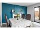Dining room with blue accent wall, fireplace, and sliding glass door at 938 Carnival Ave, Las Vegas, NV 89123