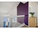 Bright entryway featuring a purple accent wall, white railing, and natural light from the front door windows at 938 Carnival Ave, Las Vegas, NV 89123