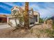 Two-story home featuring a two-car garage, desert landscaping and a beige stucco exterior at 938 Carnival Ave, Las Vegas, NV 89123