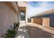 Beige stucco home with a landscaped walkway and view of the rear neighbor's roof at 938 Carnival Ave, Las Vegas, NV 89123