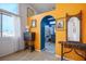 Unique hallway showcasing bright orange walls and a blue archway leading to the bathroom at 938 Carnival Ave, Las Vegas, NV 89123