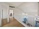 Upstairs hallway featuring wood floors, white railings and interior views at 938 Carnival Ave, Las Vegas, NV 89123