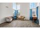 Living room with tall windows, tile flooring, and blue curtains at 938 Carnival Ave, Las Vegas, NV 89123