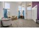 Living room with tall windows, tile flooring, and blue curtains at 938 Carnival Ave, Las Vegas, NV 89123