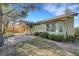 Backyard features mature trees, lush landscaping, and a covered patio on house exterior at 9485 Parkmoor Ave, Las Vegas, NV 89149