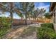 Backyard features mature trees, lush desert landscaping, and an enclosed brick perimeter at 9485 Parkmoor Ave, Las Vegas, NV 89149
