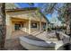 Home exterior featuring a covered patio, desert landscaping and mature trees at 9485 Parkmoor Ave, Las Vegas, NV 89149