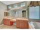 Primary bathroom featuring dual vanities, soaking tub, and natural light at 9485 Parkmoor Ave, Las Vegas, NV 89149