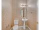 Charming half bathroom featuring decorative wallpaper and pedestal sink at 9485 Parkmoor Ave, Las Vegas, NV 89149
