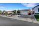 Well-maintained single-story home with a three-car garage and tidy desert landscaping at 9485 Parkmoor Ave, Las Vegas, NV 89149