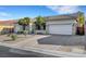 Lovely single-story home with a three-car garage, desert landscaping, and a concrete driveway at 9485 Parkmoor Ave, Las Vegas, NV 89149