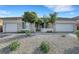 Attractive single-story home featuring desert landscaping, three-car garage, and gated front entrance at 9485 Parkmoor Ave, Las Vegas, NV 89149