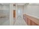 Hallway with built-in cabinets, tile flooring, and access to rooms at 9485 Parkmoor Ave, Las Vegas, NV 89149