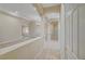 Hallway featuring tile floors, neutral paint, decorative columns, and views into the living areas at 9485 Parkmoor Ave, Las Vegas, NV 89149