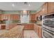 Bright kitchen featuring granite countertops, an island and stainless steel appliances at 9485 Parkmoor Ave, Las Vegas, NV 89149