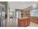 Bright kitchen featuring an island, granite countertops, and tile flooring at 9485 Parkmoor Ave, Las Vegas, NV 89149