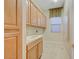 Bright laundry room featuring lots of cabinets, a sink and tile flooring at 9485 Parkmoor Ave, Las Vegas, NV 89149