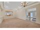 Bright living room showcasing carpet, built-ins, large windows, and elegant crown molding at 9485 Parkmoor Ave, Las Vegas, NV 89149