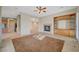 Open living room with fireplace, ceiling fan and built-in cabinets at 9485 Parkmoor Ave, Las Vegas, NV 89149