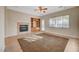 Bright living room with fireplace, built-ins, and ceiling fan at 9485 Parkmoor Ave, Las Vegas, NV 89149