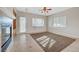 Bright living room with fireplace, ceiling fan, built-ins, and sliding glass door at 9485 Parkmoor Ave, Las Vegas, NV 89149