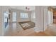 Tile-floored living area with door to the backyard, built-in cabinetry, and sliding door to the kitchen at 9485 Parkmoor Ave, Las Vegas, NV 89149