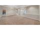 Large living space showing carpeted area, tray ceiling, tiled floors, and partial walls to other rooms at 9485 Parkmoor Ave, Las Vegas, NV 89149