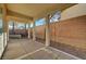 Covered patio with concrete pavers, brick wall, and desert landscaping offer a relaxing outdoor space at 9485 Parkmoor Ave, Las Vegas, NV 89149