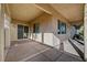 A covered patio with views of the backyard and sliding glass door access to the house at 9485 Parkmoor Ave, Las Vegas, NV 89149