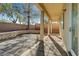 Covered patio with stone columns, and hardscape in rear yard perfect for entertaining or relaxing at 9485 Parkmoor Ave, Las Vegas, NV 89149