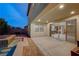 Inviting backyard with a covered patio, brick pavers, and a refreshing pool, perfect for outdoor relaxation at 1004 Bluebird Ridge Ct, North Las Vegas, NV 89084