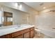 Bathroom featuring a large mirror, vanity with a sink, shower-tub combo and tile floors at 1004 Bluebird Ridge Ct, North Las Vegas, NV 89084