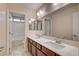 Bathroom featuring dual sinks, granite countertops, a large mirror, and a separate toilet and shower at 1004 Bluebird Ridge Ct, North Las Vegas, NV 89084