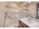 Bathroom featuring walk-in shower, white countertops, and stainless steel fixtures at 1004 Bluebird Ridge Ct, North Las Vegas, NV 89084