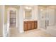 Bathroom showcasing a double sink vanity, large mirror, step-in shower, and separate tub, with walk-in closet view at 1004 Bluebird Ridge Ct, North Las Vegas, NV 89084