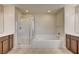 Bright bathroom featuring double vanity, large soaking tub and separate step-in shower with glass enclosure at 1004 Bluebird Ridge Ct, North Las Vegas, NV 89084