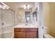 Bathroom featuring shower with glass doors, a modern vanity, and tile flooring at 1004 Bluebird Ridge Ct, North Las Vegas, NV 89084