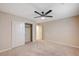 Cozy bedroom featuring plush carpeting, a ceiling fan, and a closet with plenty of space at 1004 Bluebird Ridge Ct, North Las Vegas, NV 89084