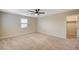 Bedroom featuring neutral carpet and paint, a ceiling fan, and a window with plantation shutters at 1004 Bluebird Ridge Ct, North Las Vegas, NV 89084