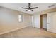 Modern bedroom featuring wood flooring, ceiling fan, walk-in closet, and bright natural light at 1004 Bluebird Ridge Ct, North Las Vegas, NV 89084