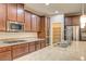 Updated kitchen features granite counters, stainless appliances, gas cooktop, and generous cabinet storage at 1004 Bluebird Ridge Ct, North Las Vegas, NV 89084