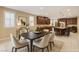 The dining area flows into a spacious open kitchen with stainless appliances and granite countertops at 1004 Bluebird Ridge Ct, North Las Vegas, NV 89084