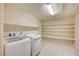 Practical laundry room with ample shelving and modern washer and dryer units at 1004 Bluebird Ridge Ct, North Las Vegas, NV 89084