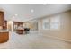 Open-concept living area with kitchen view, large windows, and tile flooring at 1004 Bluebird Ridge Ct, North Las Vegas, NV 89084