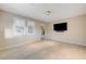 Bright living room featuring neutral paint, tile floors, and a large flat screen television at 1004 Bluebird Ridge Ct, North Las Vegas, NV 89084