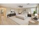 Stylishly staged primary bedroom featuring a plush bed, seating area, and neutral color palette, perfect for relaxation at 1004 Bluebird Ridge Ct, North Las Vegas, NV 89084