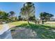 Scenic park view with lush green grass, mature trees, and picnic benches for outdoor enjoyment at 1004 Bluebird Ridge Ct, North Las Vegas, NV 89084