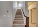 Carpeted staircase with white walls, offering a seamless transition between floors at 1004 Bluebird Ridge Ct, North Las Vegas, NV 89084