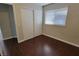 Bedroom with hardwood floors, a sliding door closet, and a large window at 1016 Vantage Point Rd, Las Vegas, NV 89128